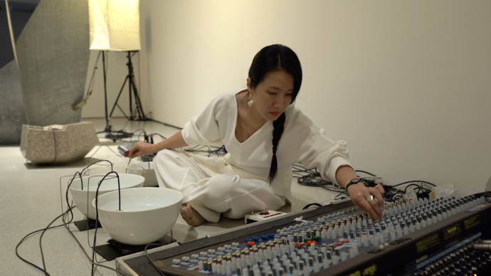 An image of Tomoko performing in the gallery