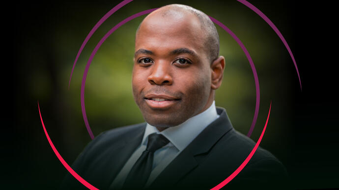 Tenor Joshua Stewart smiling at the camera, with red and purple circular swirls around him