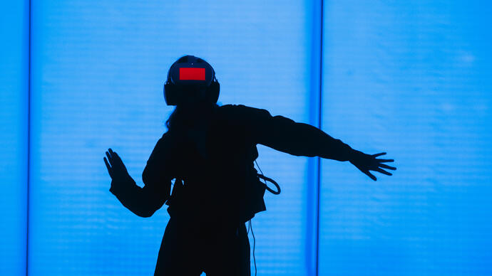 A person wears a headset, immersing themselves in a VR world