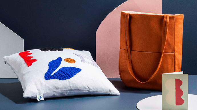 Photo of a bag mug and cushion cover by Laurie Maun in the Barbican Shop