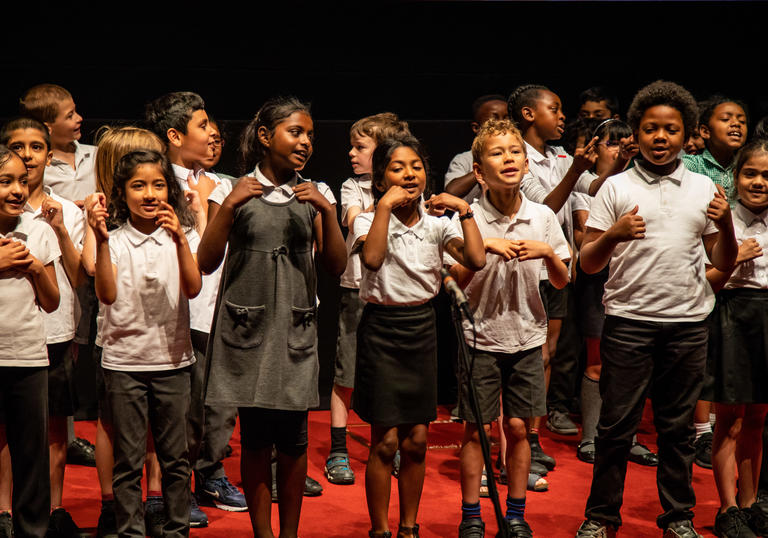 Group of students from Greenleaf School in stage performing