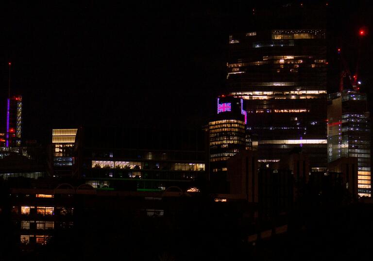 Buildings around the Barbican lit up at night time.