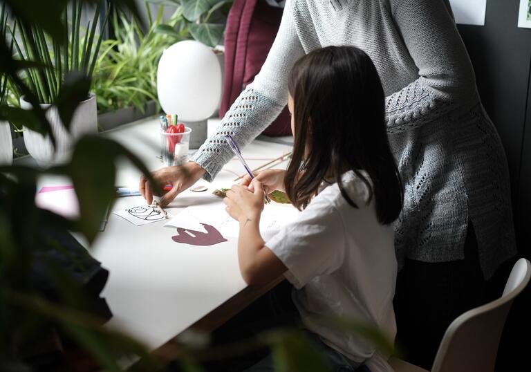 A young girl makes arts and crafts in the Barbican Cinema Cafe.