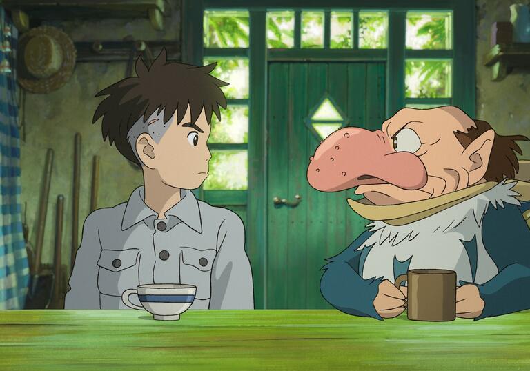 A young boy looks at an old man in an old Japanese house.
