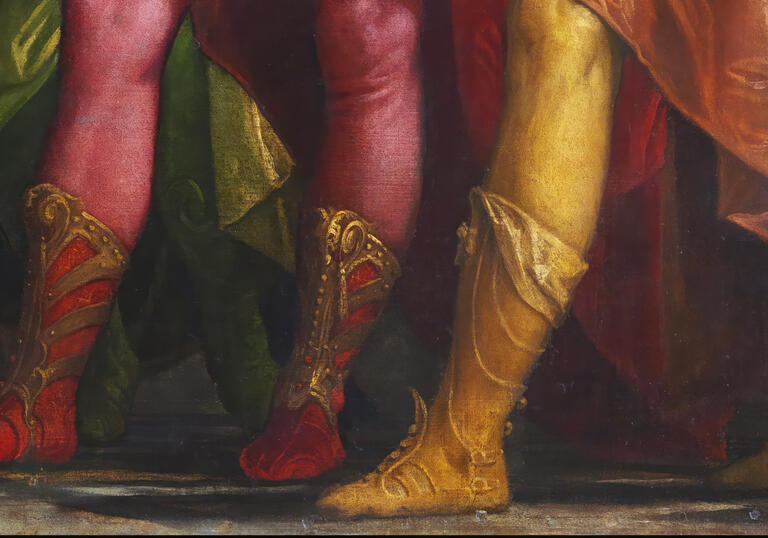 A pairing of men in boots and stockings