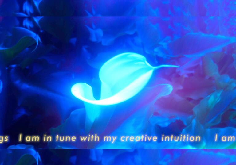 A picture of a sea creature that glows brightly. The words 'I am in tune with my creative intuition' is written across the top.