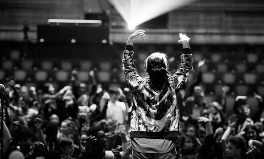 Photo of woman performing on stage in front of an audience