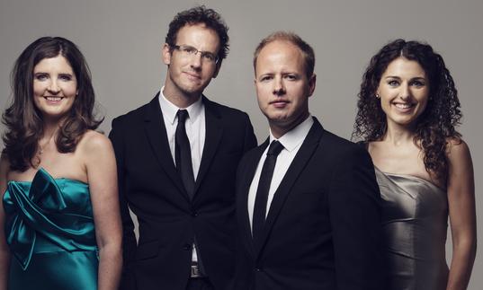 Photo of Carducci Quartet in formal dress smiling at the camera