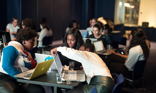 Group of young people at a table participating in a workshop