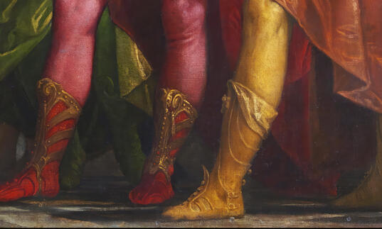A pairing of men in boots and stockings