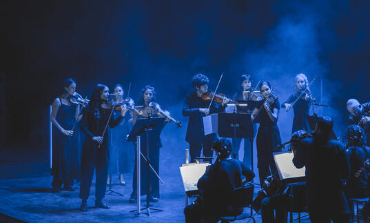 12 Ensemble performing on stage