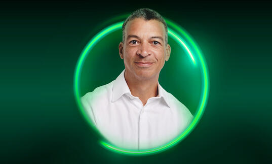 An image of Roderick Williams surrounded by a green circle against a green background