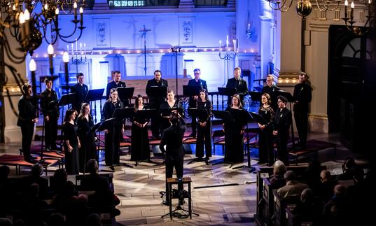 A choir singing on stage in a church